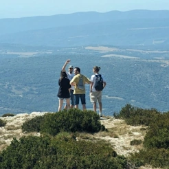 Friends and me on a cliff overlooking open land below